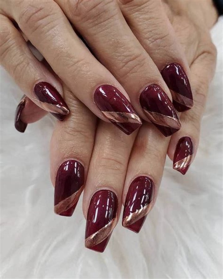 Luxurious Gold And Burgundy Nails: A Dazzling Duo